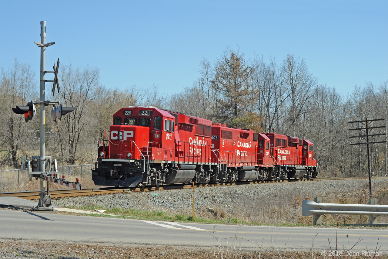 GP20c-eco locomotives CP 2211 and CP2292 with GP38-2 CP 7307 in the middle (formerly D&H, ex-Lehigh Valley) are southbound at Parkside Drive grade crossing in Waterdown.  They are returning light after helping northbound train CP 142 uphill from Hamilton to Waterdown North. According to www.cpr.ca  "Facts about CP in Hamilton"  
The grade to the north is the second steepest mountain grade on CP's network (including the Rockies) and is six miles long from Hamilton to Waterdown.
