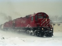 A pair of clean "Big Alco" MLW M630's CP 4571 (multimark) and CP 4562 (red & stripes) lead a CP freight train round a curve in harsh-looking winter conditions on 24 January 1992. I believe the photographer was close to his home in London ON, considering the weather, and my other images by him. Adjacent frames show a grade crossing. His camera date stamp feature imprinted the film, so date should be exact.