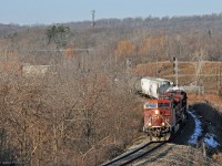 CP Train 246 lead by back-to-back steerable-truck AC4400's is southbound on the Hamilton Sub, crossing bridges over the CN Dundas sub and Ontario Highway 403. Part of the train can be glimpsed through leafless trees on the last S-curve of the descent to Desjardins. CP's approach signal for Desjardins is out of sight; CN's Dundas sub signals at the west end of Bayview can be seen. Sunny autumn/winter mornings have been rare in this part of the world recently.