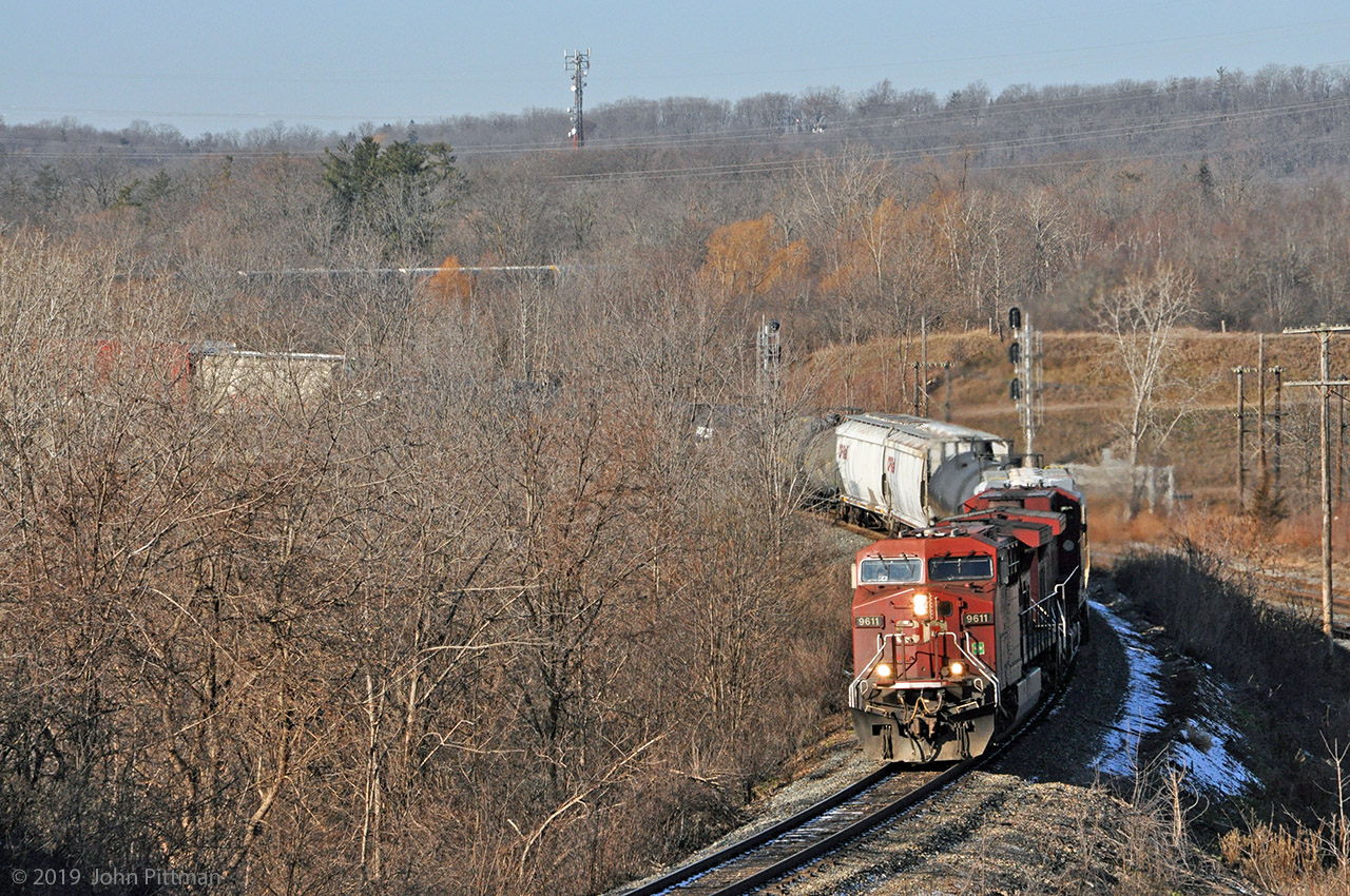 CP Train 246 lead by back-to-back steerable-truck AC4400's is southbound on the Hamilton Sub, crossing bridges over the CN Dundas sub and Ontario Highway 403. Part of the train can be glimpsed through leafless trees on the last S-curve of the descent to Desjardins. CP's approach signal for Desjardins is out of sight; CN's Dundas sub signals at the west end of Bayview can be seen. Sunny autumn/winter mornings have been rare in this part of the world recently.