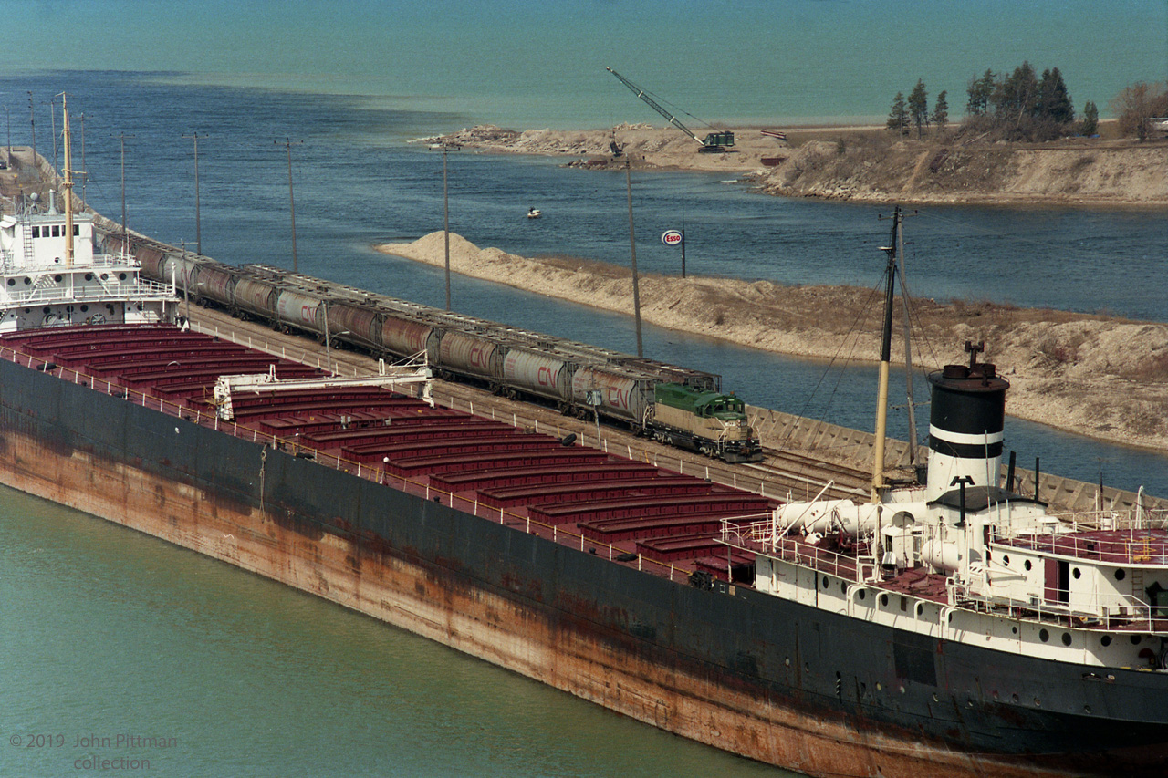 In GEXR's first week of operation, GEXR 177 is taking care of business on the dock in Goderich. Note the difference in capacity compared to the lake vessel alongside. 
Later on, GEXR 177 would haul a number of loaded salt cars up the hill to the yard, unassisted. Other pictures taken on same film that day show GEXR 179 and GEXR 180 tied up, apparently near the old Goderich station.