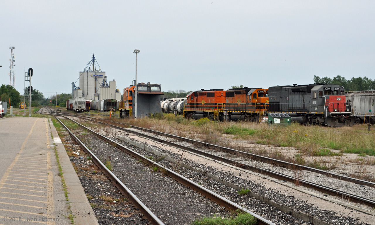 The view from Stratford station looking east toward Kitchener on 8 September 2018, late Saturday afternoon. The end of G&W operation of the Guelph subdivison was just over 2 months away.  
Visible in the yard are GEXR 3054 (SD45T-2 origin SSW & SP 9392),  GEXR 3394 (SD40-2 origin  MP 3186 ), RLHH 3403 (origin CP 5516 SD40).  Behind the un-numbered grey plow is St-Laurent & Atlantique RM-1 road slug SLQ 806, without its mother-unit.