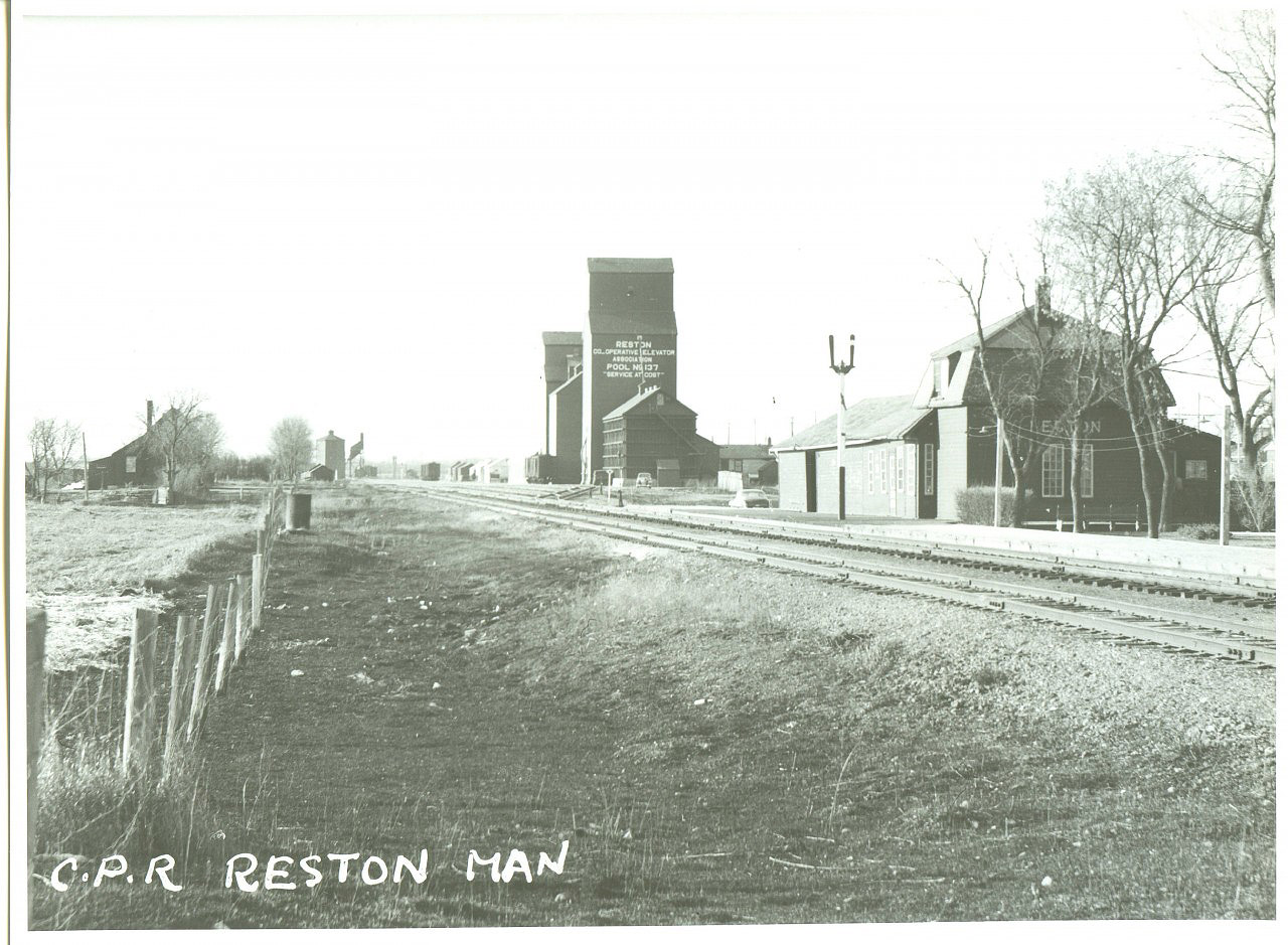 Several years ago, I asked the late Lawrence Stuckey if he had any steam era photos of Reston, my mom's home town.  He hadn't taken any but one of his wife's relatives, who lived in Nebraska, always stopped in Reston on his way to Brandon.  This photo shows the Reston station,  looking west.  The town had a small yard because the mixed trains would branch off at the far end of town onto the Reston sub which went to Wolsely, Saskatchewan.  As a kid in the early sixties, I'd hang around waiting to see if the weekly wayfreight to Arcola was coming through.  The crew always stopped the waycar by the station and unloaded LCL, mostly empty cream cans (that stunk to high heaven).  The track closest to the camera was a long passing siding.  The wye for the Reston sub was located by the coal tower in the distance.  Mr. Stuckey gave these to me and kindly gave me written permission to do whatever I wanted to do with them.  Hope you all enjoy them (there are two more to come)