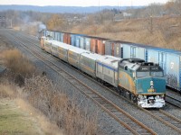 VIA train 70 (Windsor to Toronto), in a mix of colour schemes, is approaching Aldershot station on a cold winter morning. GMD F40PH-3 VIA 6405 leads a stainless steel baggage coach, 5 LRC coaches, and GE P42dc VIA 916 pushing. <br><br> Meanwhile CN train 421 (Macmillan Yard to Port Robinson) is on its way out of Aldershot Yard, easing down toward CN Snake to await its signal. CN 421 is powered by back-to-back GE Dash 8-40CM Draper taper cowls CN 2424 and CN 2436.
