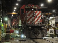 Coated in ballast dust SD40-2 CP 6045 is having a wheel trued on the wheel lathe.