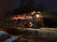 Pausing momentarily while working Guelph's South end, OSR 647's green class lights glow in the night sky