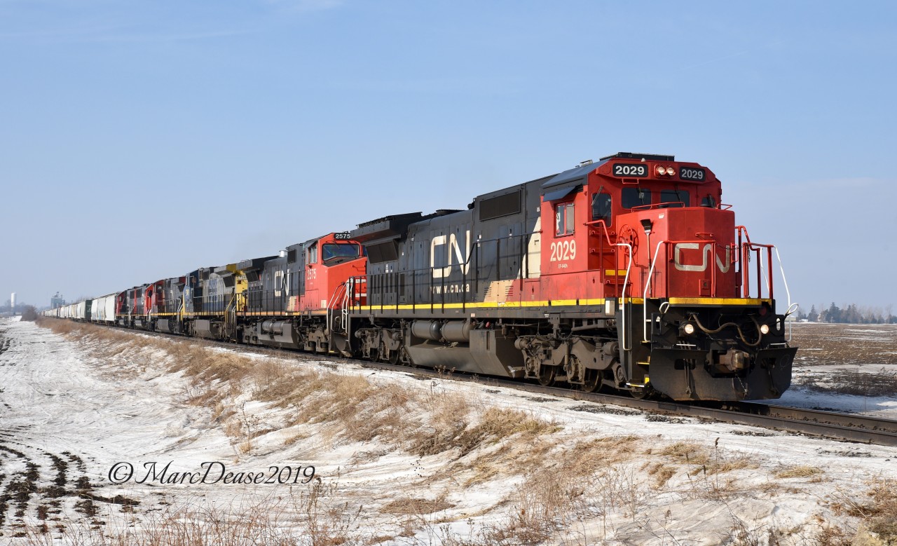 A rather large lash up on 394 with CN 2029, CN 2575, GECX 7349, IC 2707, CN 5409 and CN 5404 as pass east through Wyoming, ON., on a very frosty morning.