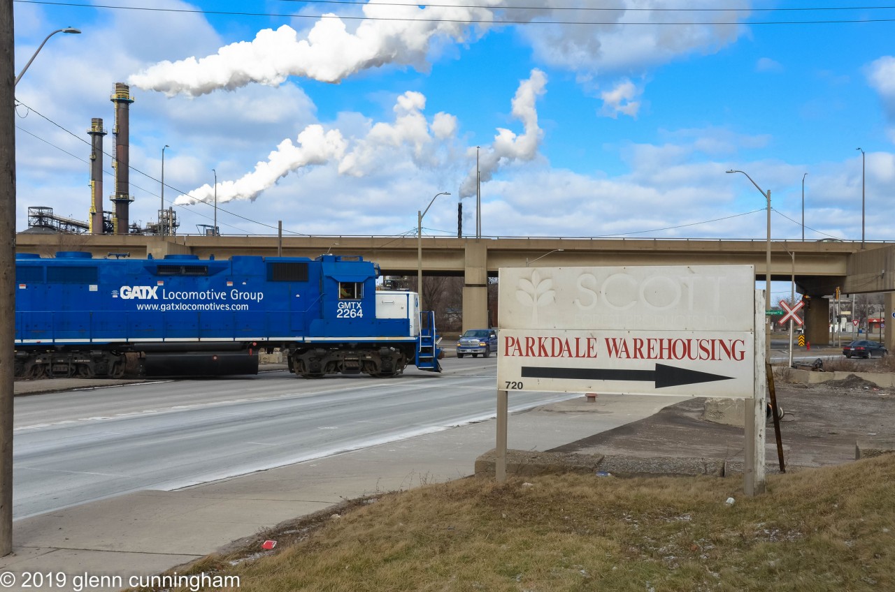 Saturday afternoon switch at Parkdale Warehousing in Hamilton's "far east" industrial area. CN is using GMTX 2264 and CN 7046 to pickup a single boxcar from the stub end track. Once ready, the crew will protect the crossing and head back to Stuart Street.