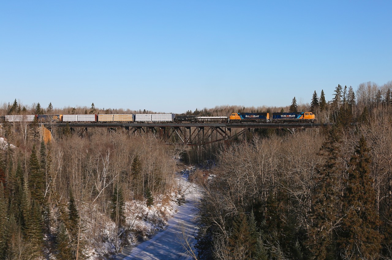 2102 and 2103 have just departed the yard in Englehart on their 138 mile journey to North Bay.  They are seen here with train 214 crossing the Englehart River.