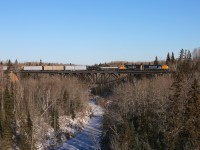 2102 and 2103 have just departed the yard in Englehart on their 138 mile journey to North Bay.  They are seen here with train 214 crossing the Englehart River.