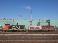 CN 7304 is seen working Parkdale Yard in Hamilton with Dofasco Central Shipping in the background.