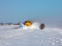 2104 hits a few small snow drifts as it leads train 214 through the farmed fields north of Earlton.  This area, which is quite open, seems to be prone to drifting and on this windy morning the hollows had already begun to fill in even though 113 had been through only an hour or so prior.