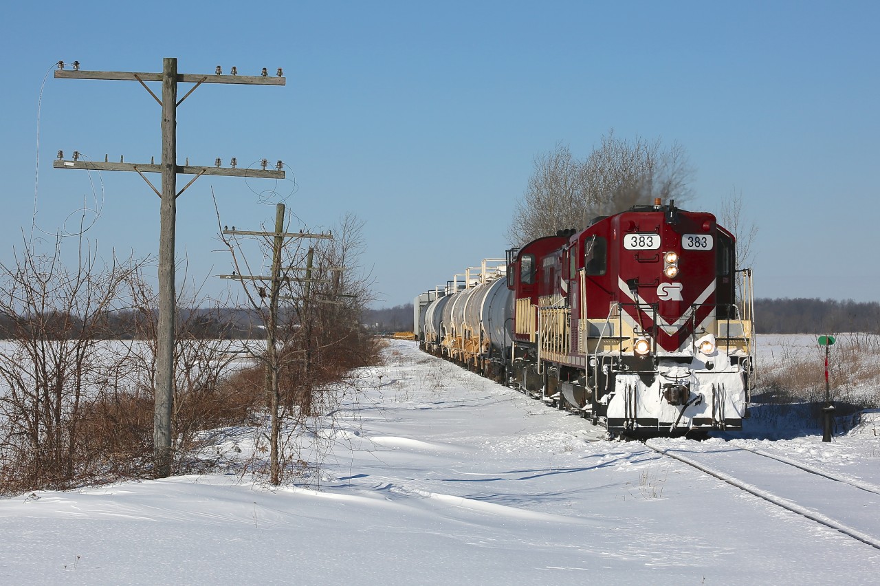 Ontario Southland locomotives 383 and 503 are on their way with a train to south Tillsonburg and Courtland.  Due to the ex CP bridge in Tillsonburg over Big Otter Creek being out of service, OSR serves south Tillsonburg/Courtland via the Cayuga Spur.  On this morning the power ran light to St Thomas, where they picked up a cut of cars that had been left by CN in the yard.  From there they headed east along the Cayuga Spur and, from what I was told, had work to do in south Tillsonburg and Courtland (I did not pursue them farther than Alymer) before retracing their steps and heading back to Salford.