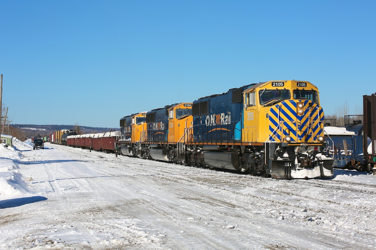 A trio of SD75I locomotives, led by the striped nose of 2105, depart Englehart on a beautiful (and cold) winter morning.