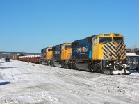 A trio of SD75I locomotives, led by the striped nose of 2105, depart Englehart on a beautiful (and cold) winter morning.