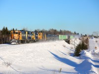 Ontario Northland train 213 is led by an interesting locomotive combination of 1802 (GP38-2), 2202 (GP40-2) and 1734 (SD40-2) as they speed past the correctional facility at Monteith with an impressive 70 cars. 1802 and 2202 had recently been utilized as power for a couple of plow extras and it seemed that they were heading home to the shops at Cochrane.