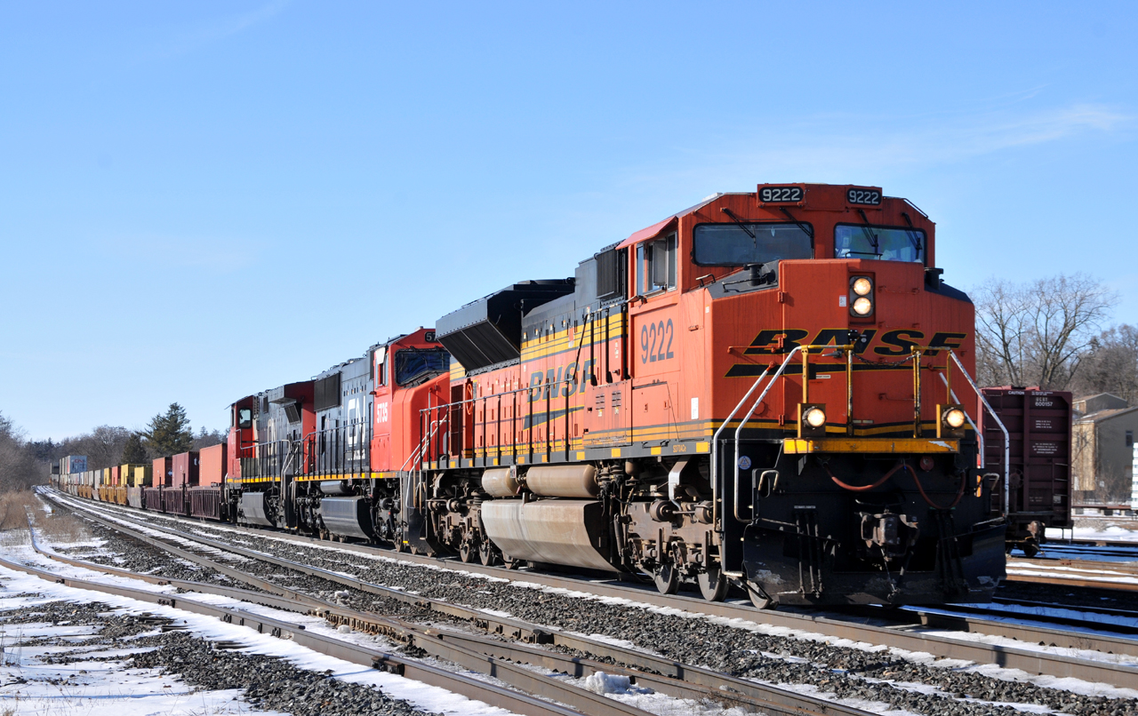 BNSF 9222, CN 5735, and IC 2702 lead CN Q14891 15 with 157 cars.
