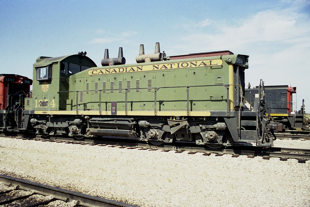 Wandering around the edge of Symington Yard many years ago I felt lucky to capture this GMD SW1200RS in the green and gold; a dress I never did see enough units in. This CN #1354, according to the Trackside Guide, was wrecked in 1983. I wonder how long it kept this gorgeous paint scheme?