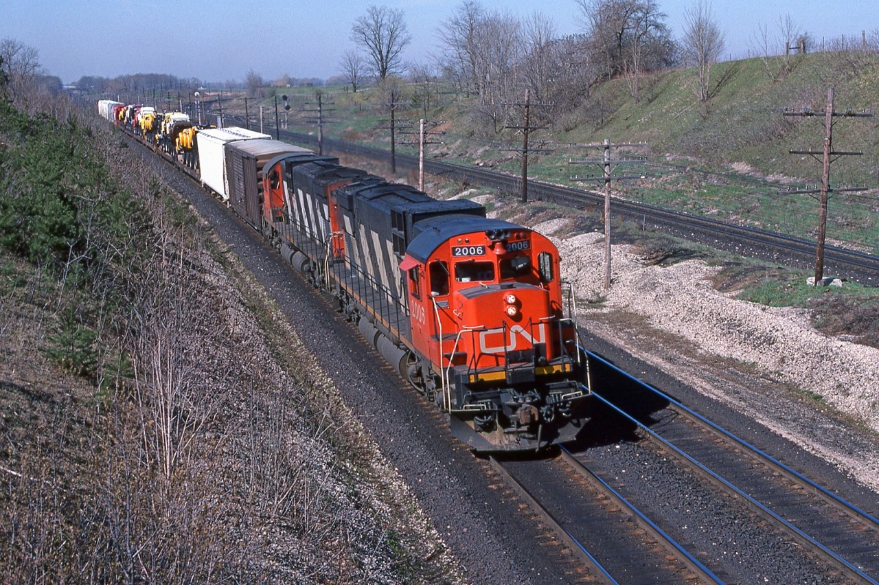 CN 2006 and helper 2012 head east with train 410 at mile 5.8 on the CN's Strathroy Sub. The CP's Windsor Sub is to the right.