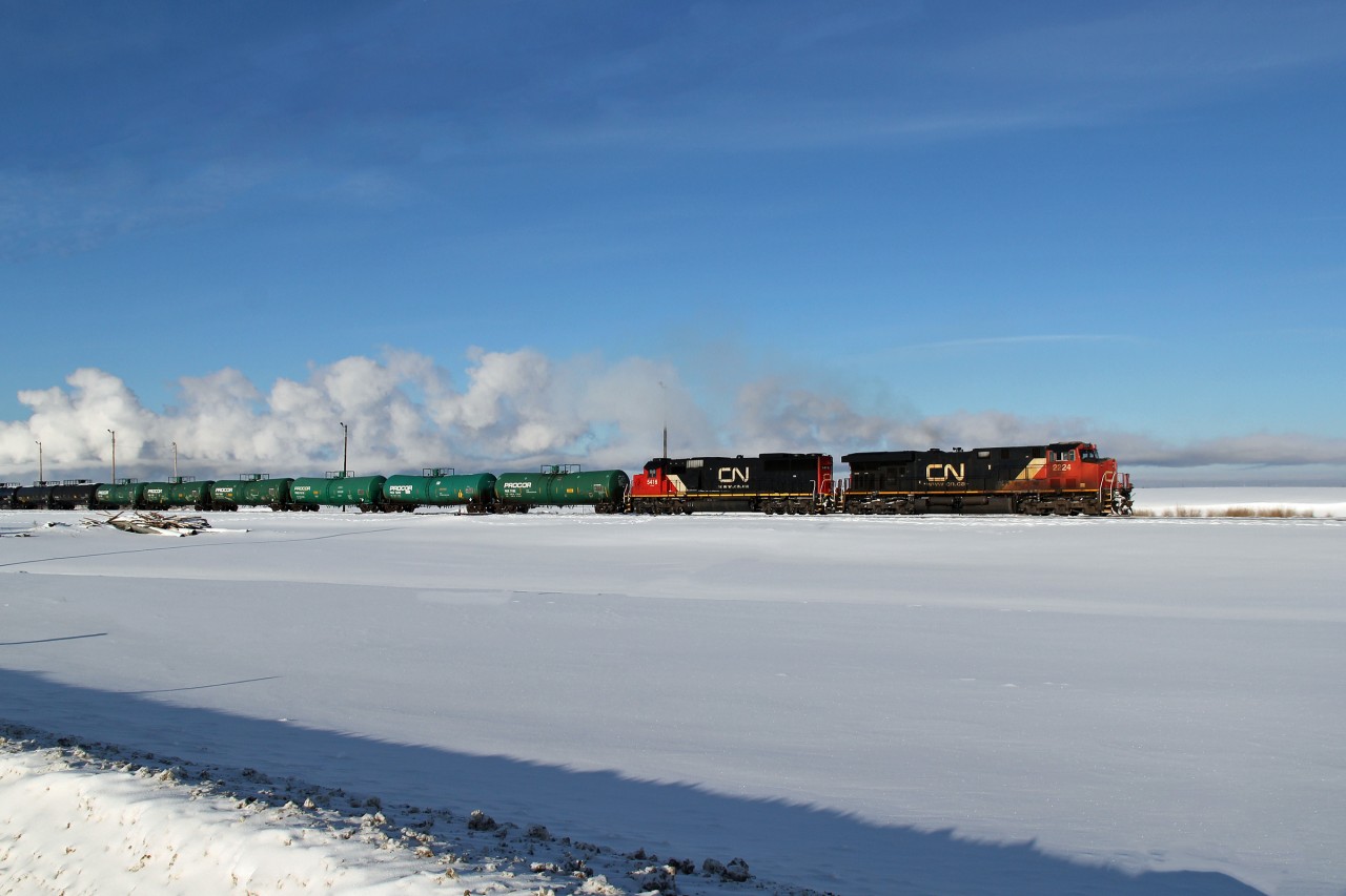ES44DC CN 2224 and SD60 CN 5416 head a train of mixed tanks east on CN's Vegreville Sub