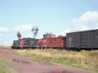 CN 30 and 40, with van 78954 are seen switching loads and empties in the Souris yard. It is September and the potato harvest is in full swing.