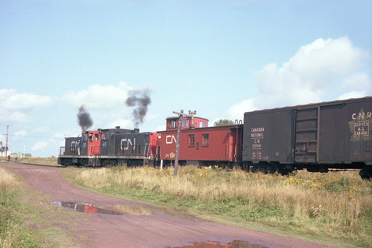 CN 30 and 40, with van 78954 are seen switching loads and empties in the Souris yard. It is September and the potato harvest is in full swing.