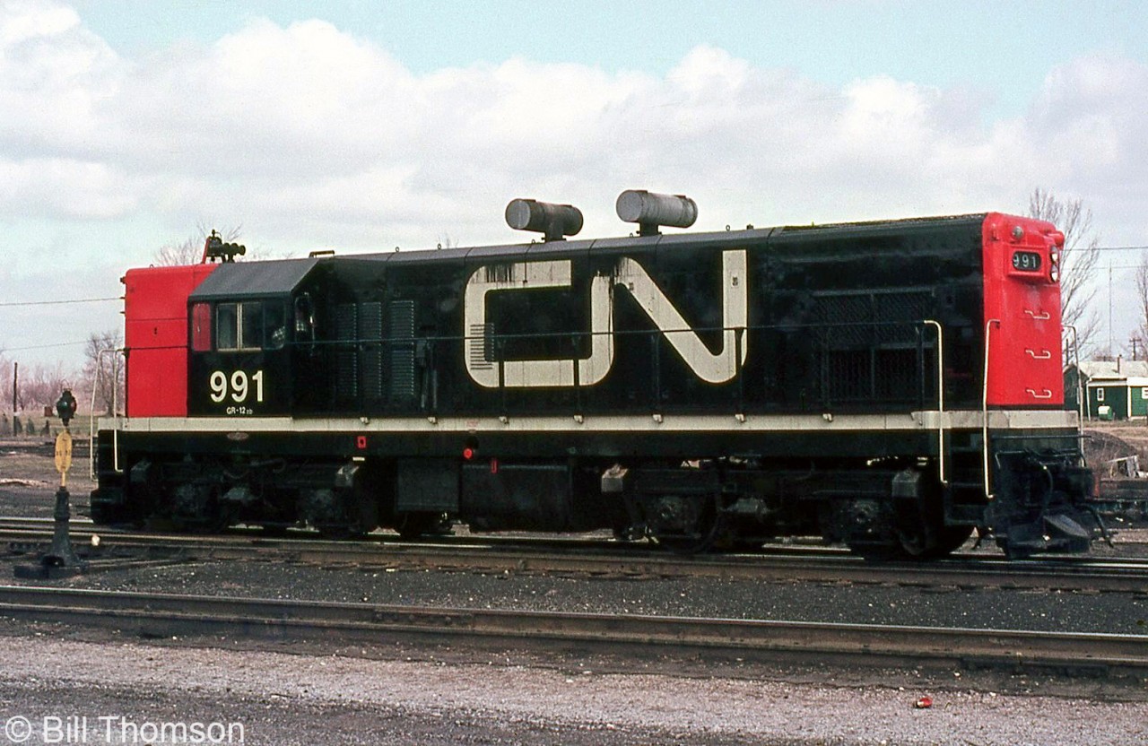 Now sporting modern CN colours as well as a pair of spark arrestors, CN G12 991 is seen parked at St. Thomas in 1969, not too long before being sent out west to BC with former LP&S sister unit 992. There were subtle differences between the two units, including truck type and cab style.