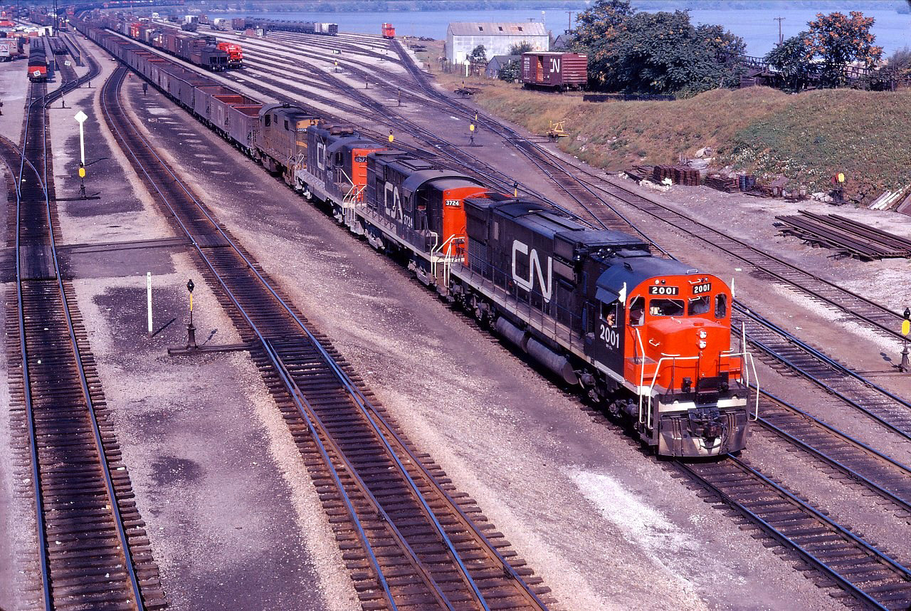In addition to the "Dofasco" ore train, CN occasionally ran ore trains to points in the United States through Hamilton and Fort Erie. (Perhaps another member can comment on how often such trains ran and their destinations.) In any case, this train has a nice consist of new C630m 2001 (delivered in August!), as well as RS18 3724, GP9 4573, and RS18 3859.