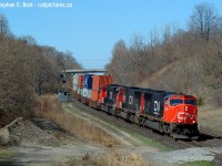 A nice three pack of, at the time, nice looking and clean SD75's leads train 148 down the hill at Copetown. The shack is for a 'switchtender' ? whose sole job was to monitor track conditions as there is an underground river/lake of some kind at this location. In the last few years some major underground water management system was installed in this location.. and there remains detectors here for sinkholes in case of a problem. Curious if one has ever happened..