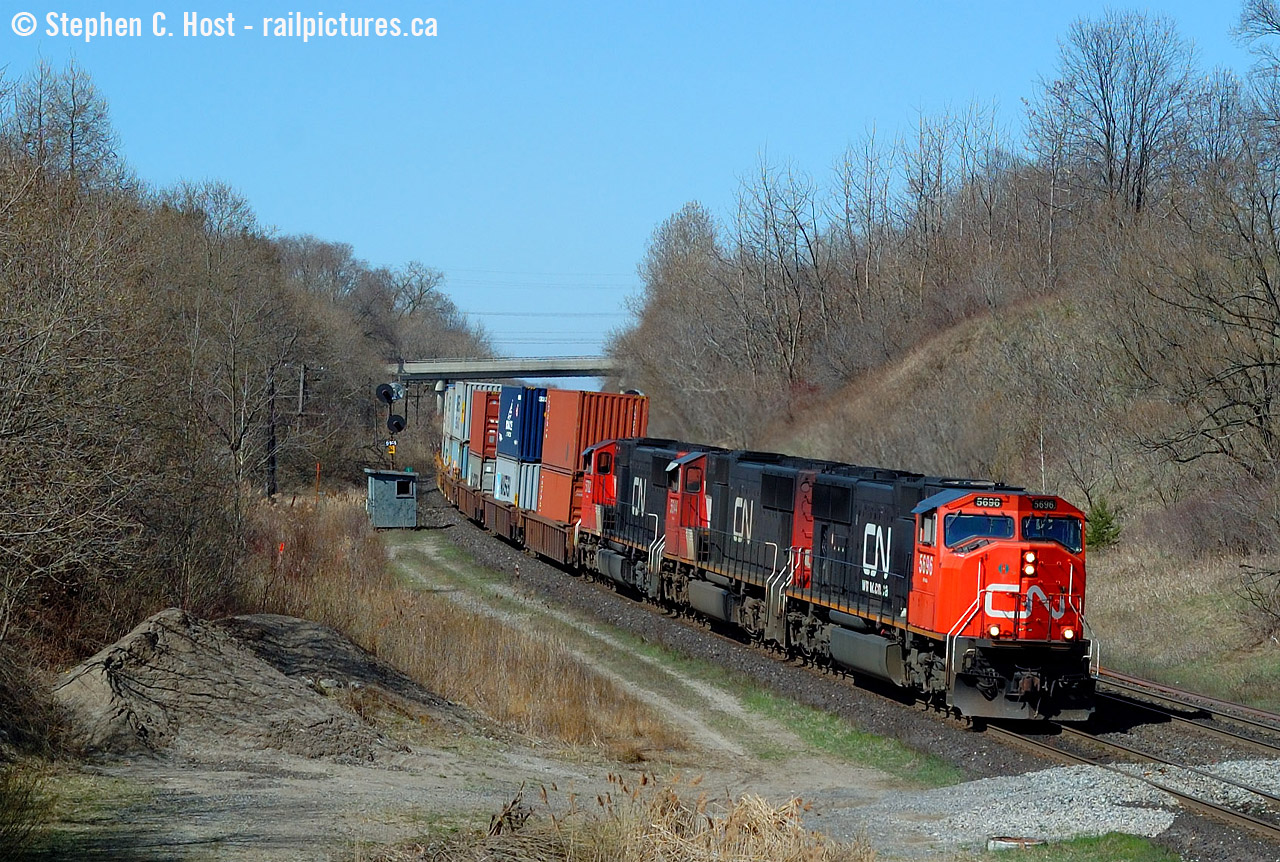 A nice three pack of, at the time, nice looking and clean SD75's leads train 148 down the hill at Copetown. The shack is for a 'switchtender' ? whose sole job was to monitor track conditions as there is an underground river/lake of some kind at this location. In the last few years some major underground water management system was installed in this location.. and there remains detectors here for sinkholes in case of a problem. Curious if one has ever happened..