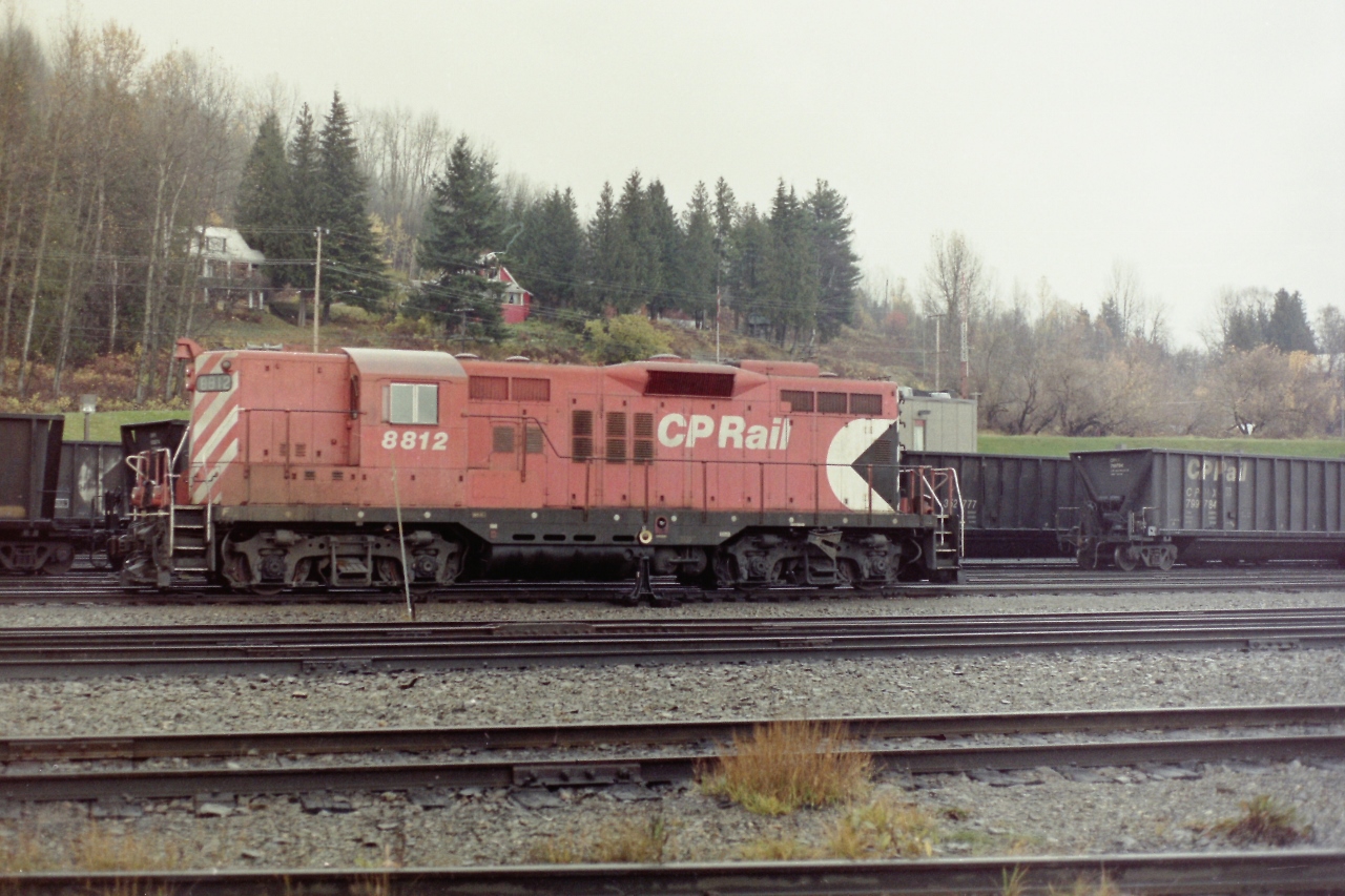We are going back a few years, but if I remember correctly this picture was taken from the edge of the CPR property. The weather on that day was typical for someone who worked out of the lower mainland. A dull day with "Liquid Sunshine". CP 8812 was working the yard so I just stood there and watched it for awhile, then I photographed it. If you had the proper personal equipment, and a signed release it was easy to carefully photograph the Revelstoke yards. Today Revelstoke is a shell of what it once was, but Golden is happy. For history's sake I'm glad I caught a few of the first generation diesel locomotives. I used to be able to say  that the London built GM locomotives were made just down the street from where I grew up, but I can't say that any more!