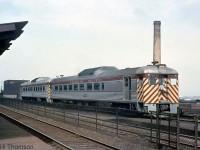 CP RDC-2 9109 and a 90xx-series RDC-1 are seen passing the platforms at CP's Westmount Station in Montreal QC.<br><br>CP 9109 was built in 1955 by Budd as an RDC-2 (passenger seating with a small baggage area), later rebuilt into an "RDC-5" by CP in the mid-70's (RDC-5 was CP's term for an RDC-2 converted into RDC-1 with the baggage section removed and more seating), and was sold to VIA in 1978 to become VIA 6138. It was eventually retired by VIA and sold to Farmrail in 1999, but has languished unused at VIA's Toronto Maintenance Centre where it remains to this day. 