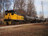 Seen here from Senator Paul Lucier Park, 107 heads through the suburbs of Lasalle with 39 tank cars after switching in Amherstburg roughly 15 km south of here.