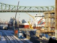 After bringing in an intermodal transfer, GMTX 2257, CN 227 and CN 7233 are leaving the Port of Montreal light power. At right the ships <i>CSL St-Laurent</i> and <i>CSL Laurentien</i> are laid up for the winter. The latter ship features special artwork on its superstructure to commemorate Canada's 150th anniversary (2018) as well as Montreal's 375th anniversary (2017).
