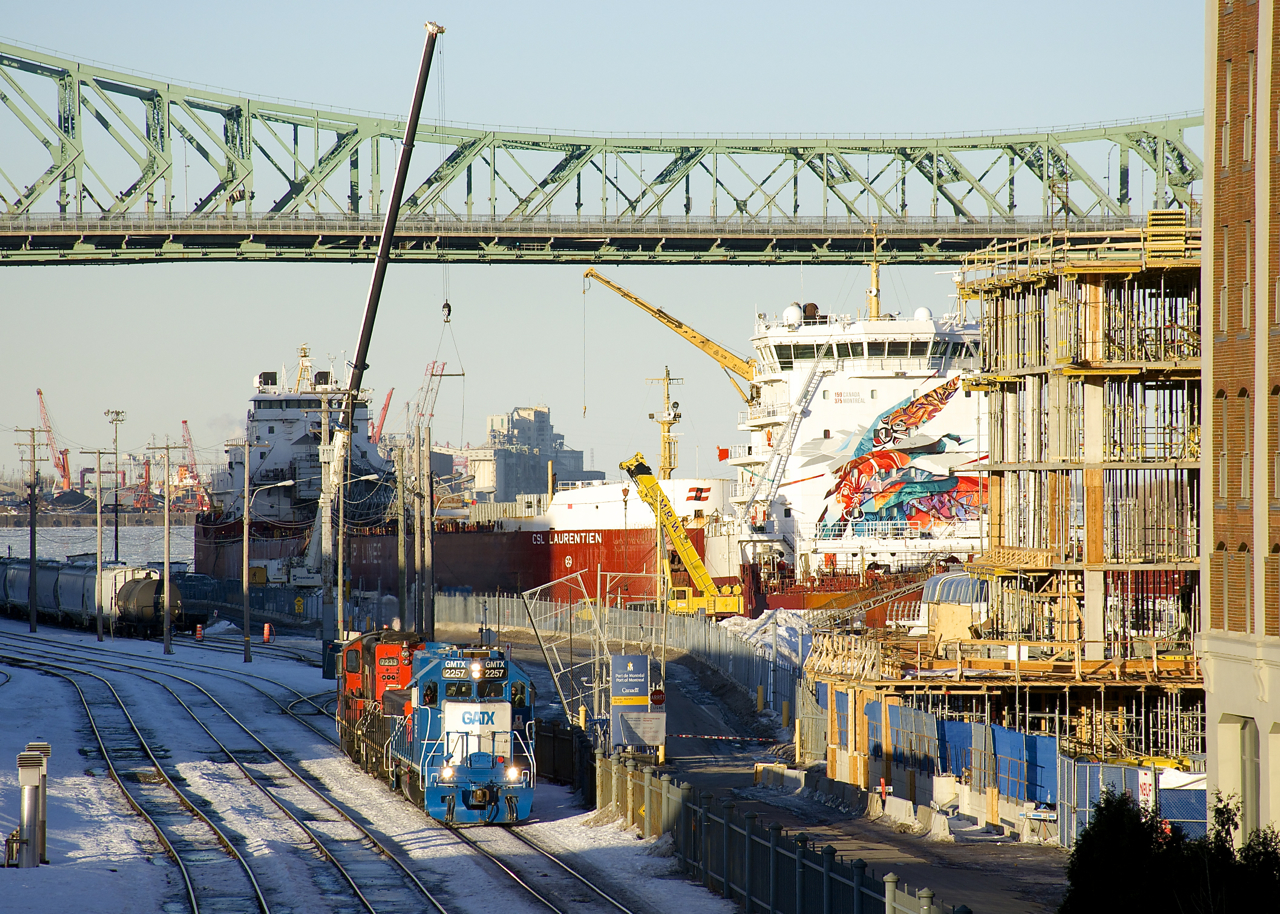 After bringing in an intermodal transfer, GMTX 2257, CN 227 and CN 7233 are leaving the Port of Montreal light power. At right the ships CSL St-Laurent and CSL Laurentien are laid up for the winter. The latter ship features special artwork on its superstructure to commemorate Canada's 150th anniversary (2018) as well as Montreal's 375th anniversary (2017).