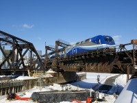 AMT 1352 pushes a deadhead move towards Central Station a bit before the afternoon rush hour. Work continues to progress on the REM light rail project (which will parallel the tracks here), with what might be a pillar going up in the Lachine Canal, which will certainly affect this angle.