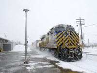 CN 310 with CREX 1512 up front and CN 3842 mid-train (and 149 cars) roars past Dorval Station, kicking up the powder on a snowy afternoon.