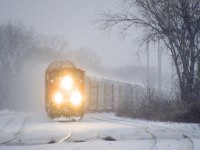 CN 271 with 101 autoracks and CN 8907 & CSXT 8138 for power negotiates the s-curve at Dorval in the snow.