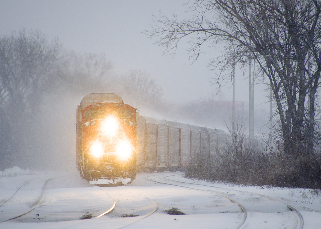 CN 271 with 101 autoracks and CN 8907 & CSXT 8138 for power negotiates the s-curve at Dorval in the snow.