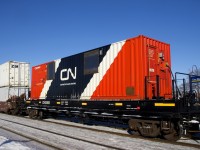 Distributed braking container CN 0005 is helping CN X106 maintain its air as it heads east through Dorval, its journey nearly over. CN has a number of these, as well as distributed braking cars built from boxcars.