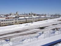 Eight of the nine gallery cars built by Canadian Vickers for CP in 1969 (and currently stored for many years) now sit in the Pointe-Saint-Charles Maintenance Centre on a sunny morning. The ninth car is at far right, coupled to an ex-GO Transit single level car and a Bombardier multilevel car.