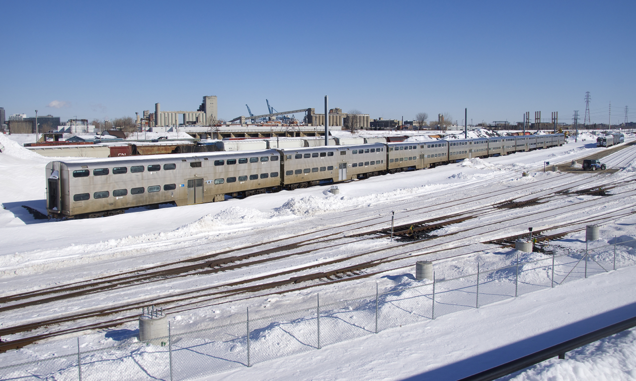 Eight of the nine gallery cars built by Canadian Vickers for CP in 1969 (and currently stored for many years) now sit in the Pointe-Saint-Charles Maintenance Centre on a sunny morning. The ninth car is at far right, coupled to an ex-GO Transit single level car and a Bombardier multilevel car.