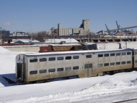 With stored gallery car AMT 926 at ground level in Pointe St-Charles Maintenance Centre, the <i>Adirondack</i> is leaviing Montreal on the high level St-Hyacinthe Sub with AMTK 2 and five Amfleet cars.