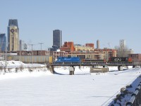 The Pointe St-Charles Switcher is crossing the Lachine Canal on its way back to its namesake yard with single bad ordered autorack in tow (picked up on track 29 just west of the De Courcell crossing). Power is CN 7233, CN 227 and GMTX 2257.