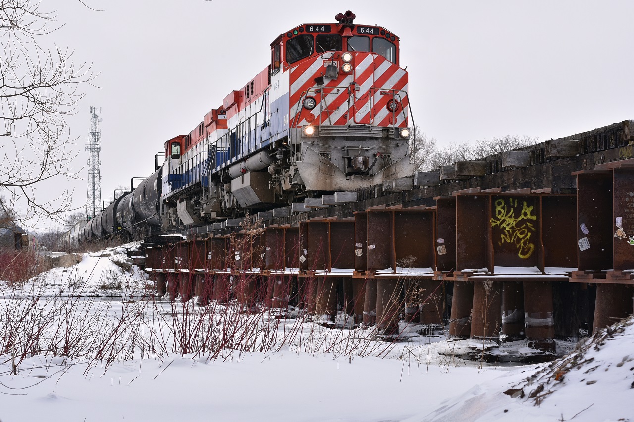OSR's matching M420W pair with green class lights lit depart Guelph's South end crossing the Eramosa River on an extra weekend run