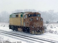 While this mystery unit is in unpainted primer, hints of green on the pre-painted components and the numberboards reveal her identity: brand new GO Transit F59PH 539, still in an unpainted and semi-primered state, stretches her legs on the test track at the GMD London locomotive assembly plant on a snowy winter's day. At the time GMD was building GO Transit's second order of F59PH commuter locomotives, units 536-547 (GCE-430h class) and 539, serial number A-4878, was the 4th unit constructed. She would hit the paint shop and emerge fully painted and lettered for her new owner a week or two later, along with sister unit 538. <br><br> The F59PH invasion would continue for a further two orders, and completely eradicate the remaining pre-F59 power from GO's roster (the GP40-2W's, F40PH's, rebuilt ex-ROCK GP40-3's and APCU/APU F-units). 539 would soldier on for two decades in commuter service, until eventual retirement and sale Rosen Beaudin (RB) Leasing in March 2010 with a few sister units. While RBRX has sold off almost all of its ex-GO F59's (and scrapped a few), 539's disposition after is unknown. <br><br> <i>Gord Taylor photo, Dan Dell'Unto collection slide.</i>