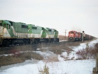 Back in the days when CP was running power-short and using everything they could get their hands on; they 'borrowed' GO Transit power on weekends to help out. Here is a solid set on an eastbound train, GO 723,725 and 722 meeting westbound CP 5724, 5916 and B&O 3733 as witnessed at the east end of the siding at Coakley. I used to be able to drive in over the road bridge at the Pittock Conservation Area in the off-season, but now I believe the area is gated.