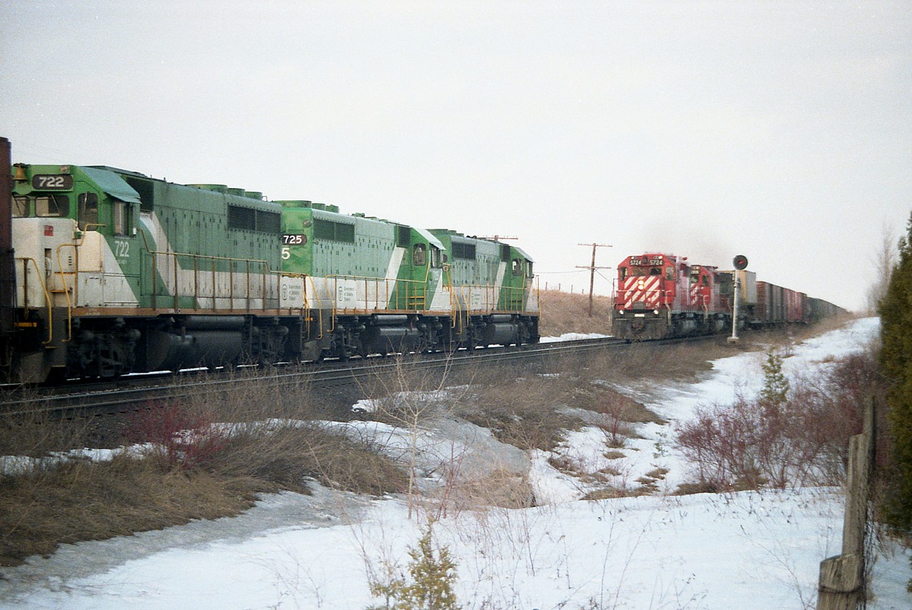 Back in the days when CP was running power-short and using everything they could get their hands on; they 'borrowed' GO Transit power on weekends to help out. Here is a solid set on an eastbound train, GO 723,725 and 722 meeting westbound CP 5724, 5916 and B&O 3733 as witnessed at the east end of the siding at Coakley. I used to be able to drive in over the road bridge at the Pittock Conservation Area in the off-season, but now I believe the area is gated.