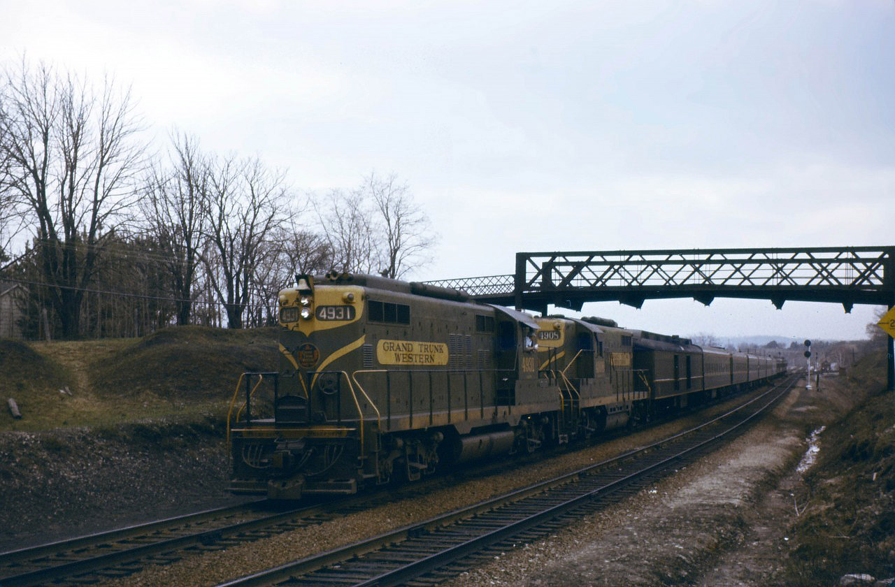 Train 6, the "Inter-City Limited" from Chicago to Toronto and Montreal prepares to back into Hamilton in early 1962. If you look closely, you can see a crew member in the cab of the 4931 looking for the signal/watching the back-up move into Hamilton and the last car starting through the crossover to the westward track (remember, it was "right hand running" in those days prior to bi-directional CTC). Prior to April 29, 1962, trains to and from southwestern Ontario made station stops in Hamilton--backing to Bayview before continuing west and backing into Hamilton before continuing east. Trains to and from London (Nos. 80/83) Windsor (Nos. 9/18), and Chicago (Nos. 5/6 and 14/15) which did this had a three hour schedule between London and Toronto, compared to 2:10 or 2:15 for those which by-passed Hamilton (Nos. 75/82 to/from Sarnia). At the end of April 1962, the back-up move was eliminated for most trains.