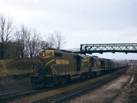 Train 6, the "Inter-City Limited" from Chicago to Toronto and Montreal prepares to back into Hamilton in early 1962. If you look closely, you can see a crew member in the cab of the 4931 looking for the signal/watching the back-up move into Hamilton and the last car starting through the crossover to the westward track (remember, it was "right hand running" in those days prior to bi-directional CTC). Prior to April 29, 1962, trains to and from southwestern Ontario made station stops in Hamilton--backing to Bayview before continuing west and backing into Hamilton before continuing east. Trains to and from London (Nos. 80/83) Windsor (Nos. 9/18), and Chicago (Nos. 5/6 and 14/15) which did this had a three hour schedule between London and Toronto, compared to 2:10 or 2:15 for those which by-passed Hamilton (Nos. 75/82 to/from Sarnia). At the end of April 1962, the back-up move was eliminated for most trains.